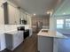 Well-appointed kitchen with stainless steel appliances, gray cabinetry, and a functional island, perfect for meal preparation at 154 N Finley Landing Pkwy, Smithfield, NC 27577