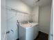 Functional laundry room with modern washer and dryer units, ample storage shelves, and a clean, efficient design at 154 N Finley Landing Pkwy, Smithfield, NC 27577