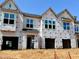 New construction townhomes feature garages and large windows ready for customization at 157 Ripple Way # 207, Clayton, NC 27520