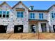 New construction home showcasing large windows, durable wrap, and open garage with a blue sky above at 161 Ripple Way # 206, Clayton, NC 27520