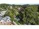 Overhead angle of a house surrounded by lush trees, near a new construction site on a beautiful sunny day at 1811 Ridley St, Raleigh, NC 27608