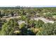 High angle of residential area showing mature trees, houses, businesses, and a distant skyline view at 1811 Ridley St, Raleigh, NC 27608