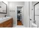 Stylish bathroom with walk-in closet, modern vanity, and sleek black hardware at 1811 Ridley St, Raleigh, NC 27608