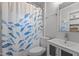 Bright bathroom featuring a vanity with a sink, toilet, and shower with decorative curtain at 1811 Ridley St, Raleigh, NC 27608