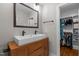 Elegant bathroom with dual vanity, large mirror, and access to a closet at 1811 Ridley St, Raleigh, NC 27608