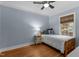 Cozy bedroom with hardwood floors, a ceiling fan, and a window providing natural light at 1811 Ridley St, Raleigh, NC 27608