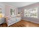 Bright bedroom with two windows providing ample natural light and hardwood flooring at 1811 Ridley St, Raleigh, NC 27608