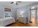 Bedroom with wooden floors, a window with blinds, and a view into the hall at 1811 Ridley St, Raleigh, NC 27608