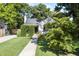 Charming home with a manicured lawn, lush greenery framing the entrance, and a welcoming walkway at 1811 Ridley St, Raleigh, NC 27608