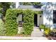 Charming front entrance with lush greenery, a cozy seating area, and a glimpse of the house number at 1811 Ridley St, Raleigh, NC 27608