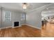 Open floor plan with fireplace and hardwood floors with archway to other living area at 1811 Ridley St, Raleigh, NC 27608