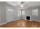 Bright and open living room featuring hardwood floors and natural light from multiple windows at 1811 Ridley St, Raleigh, NC 27608
