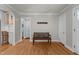 Open-concept living room with wood bench, tile backsplash, hardwood floors and neutral paint at 1811 Ridley St, Raleigh, NC 27608