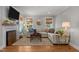 Inviting living room with hardwood floors, a fireplace, and ample natural light at 1811 Ridley St, Raleigh, NC 27608