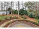 Backyard featuring fresh landscaping with a shed in the background and mature trees at 1821 Kelly Glen Dr, Apex, NC 27502