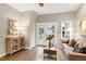 Inviting living room featuring a sofa, coffee table, lamps, and access to the backyard through French doors at 1821 Kelly Glen Dr, Apex, NC 27502