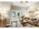 Bright living room with modern decor, French doors, stylish furniture, and beautiful hardwood floors at 1821 Kelly Glen Dr, Apex, NC 27502