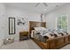 Bedroom featuring a wooden frame bed, a zebra print bedspread, and a ceiling fan at 186 Ross Dr, Pittsboro, NC 27312