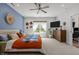 Bright bedroom featuring a sitting area by the window, a ceiling fan, and decorative wall art at 186 Ross Dr, Pittsboro, NC 27312
