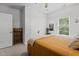 Bedroom with a bed and a wooden display shelf, closet, and ceiling fan at 186 Ross Dr, Pittsboro, NC 27312