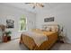 Bedroom with a window view, ceiling fan, wood decor, and a tan colored bed at 186 Ross Dr, Pittsboro, NC 27312