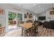 Inviting dining area with a wooden table, comfortable seating, and access to the outdoor deck and living space at 186 Ross Dr, Pittsboro, NC 27312