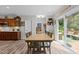 Charming dining area with a wooden table, access to the backyard deck, and views of the kitchen at 186 Ross Dr, Pittsboro, NC 27312