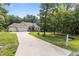 Inviting home with a long driveway, well-maintained lawn, and beautifully landscaped surroundings at 186 Ross Dr, Pittsboro, NC 27312