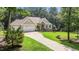 Charming home with a stone arched entryway, attached garage, and well manicured lawn at 186 Ross Dr, Pittsboro, NC 27312