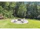 Fire pit with chairs on a backyard patio at 186 Ross Dr, Pittsboro, NC 27312