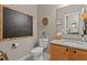 Stylish half bathroom with a granite countertop, decorative mirror, and modern fixtures at 186 Ross Dr, Pittsboro, NC 27312