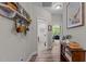 Hallway featuring hardwood floors, decor shelves and vases, leading to an office and bedroom at 186 Ross Dr, Pittsboro, NC 27312
