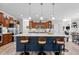Kitchen featuring a large island with seating, stainless steel appliances, and custom cabinetry at 186 Ross Dr, Pittsboro, NC 27312