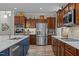 Modern kitchen featuring stainless steel appliances, wood cabinets, and a spacious island with quartz countertops at 186 Ross Dr, Pittsboro, NC 27312