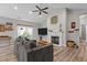 Cozy living room with high ceilings, a fireplace, a ceiling fan, and plenty of natural light at 186 Ross Dr, Pittsboro, NC 27312
