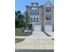 Attractive brick townhome featuring an attached two-car garage and well-manicured lawn at 1909 Fishamble St # 16, Fuquay Varina, NC 27526