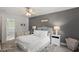 Comfortable bedroom with a gray accent wall, plush carpet, and ceiling fan at 1990 Ferbow St, Creedmoor, NC 27522