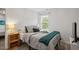 Comfortable bedroom featuring neutral walls, plush carpet, and natural light at 1990 Ferbow St, Creedmoor, NC 27522