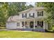 Beautiful two-story home with a classic front porch, rocking chairs, and a well-maintained lawn and landscaping at 1990 Ferbow St, Creedmoor, NC 27522