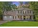 Charming two-story home featuring a welcoming front porch with rocking chairs and a well-manicured lawn at 1990 Ferbow St, Creedmoor, NC 27522