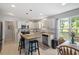 Bright kitchen with white cabinets, an island with seating, and a dining area for casual meals at 1990 Ferbow St, Creedmoor, NC 27522