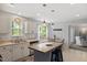Functional kitchen featuring white cabinets, a central island, and an adjacent dining area for easy entertaining at 1990 Ferbow St, Creedmoor, NC 27522