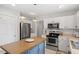 Well-equipped kitchen with stainless steel appliances, a center island, and ample cabinet space at 1990 Ferbow St, Creedmoor, NC 27522