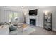 Bright living room featuring a cozy fireplace, comfortable seating, and access to an outdoor patio at 1990 Ferbow St, Creedmoor, NC 27522