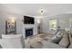 Comfortable living room with a fireplace, neutral decor, and large windows for natural light at 1990 Ferbow St, Creedmoor, NC 27522