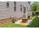 Backyard with a fire pit and a hose reel next to the house with vinyl siding at 220 W Winmore Ave, Chapel Hill, NC 27516