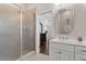 Elegant bathroom featuring a clear glass shower door and vanity area with cabinets at 220 W Winmore Ave, Chapel Hill, NC 27516