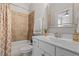 Charming bathroom featuring a tile shower-over-tub and a white vanity with marble countertop and chrome fixtures at 220 W Winmore Ave, Chapel Hill, NC 27516