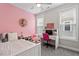 Adorable pink bedroom with a cozy bed, white desk, and natural light streaming in from the bright window at 220 W Winmore Ave, Chapel Hill, NC 27516