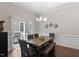 Well-lit dining room with slider doors to deck, dark hardwood, and modern lighting at 220 W Winmore Ave, Chapel Hill, NC 27516